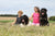 two children with newfoundland and other large dog