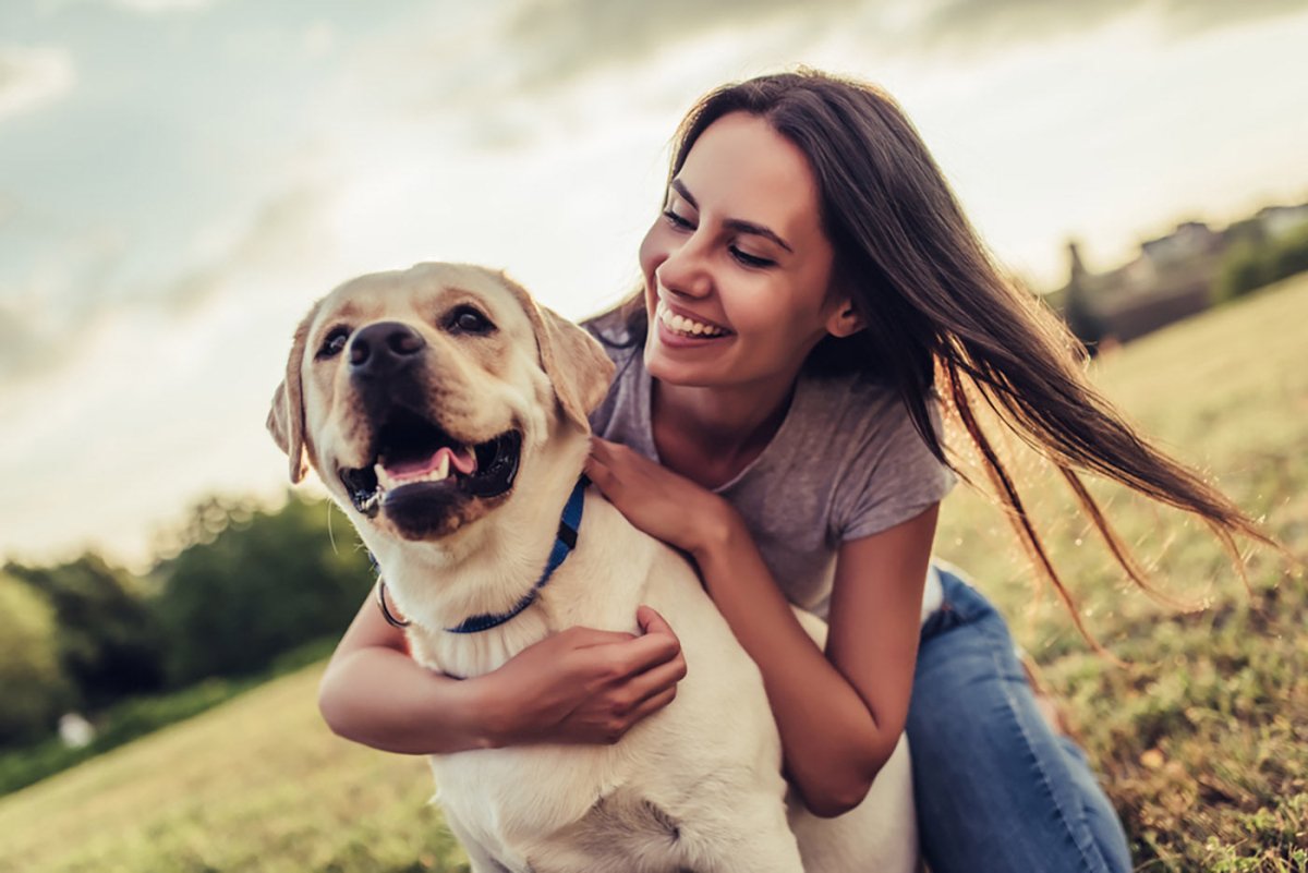 happy woman hugging dog