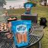 A dog is sitting on a grill next to a bag of Best Bully Sticks&#39; Hickory Smoked Beef Trachea 10pk.