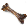 A Monster Femur Bone from Best Bully Sticks in a plastic bag on a white background.